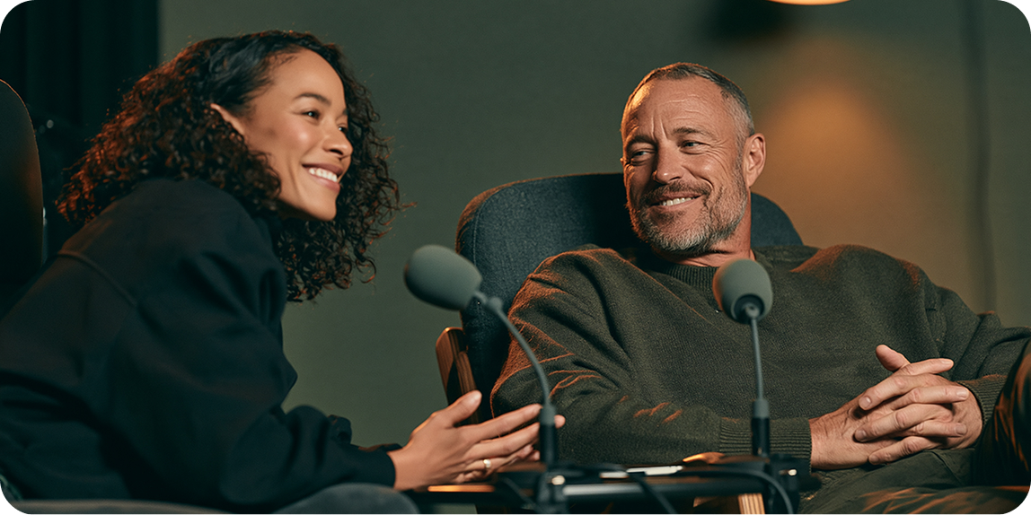 Two people recording a podcast in a studio